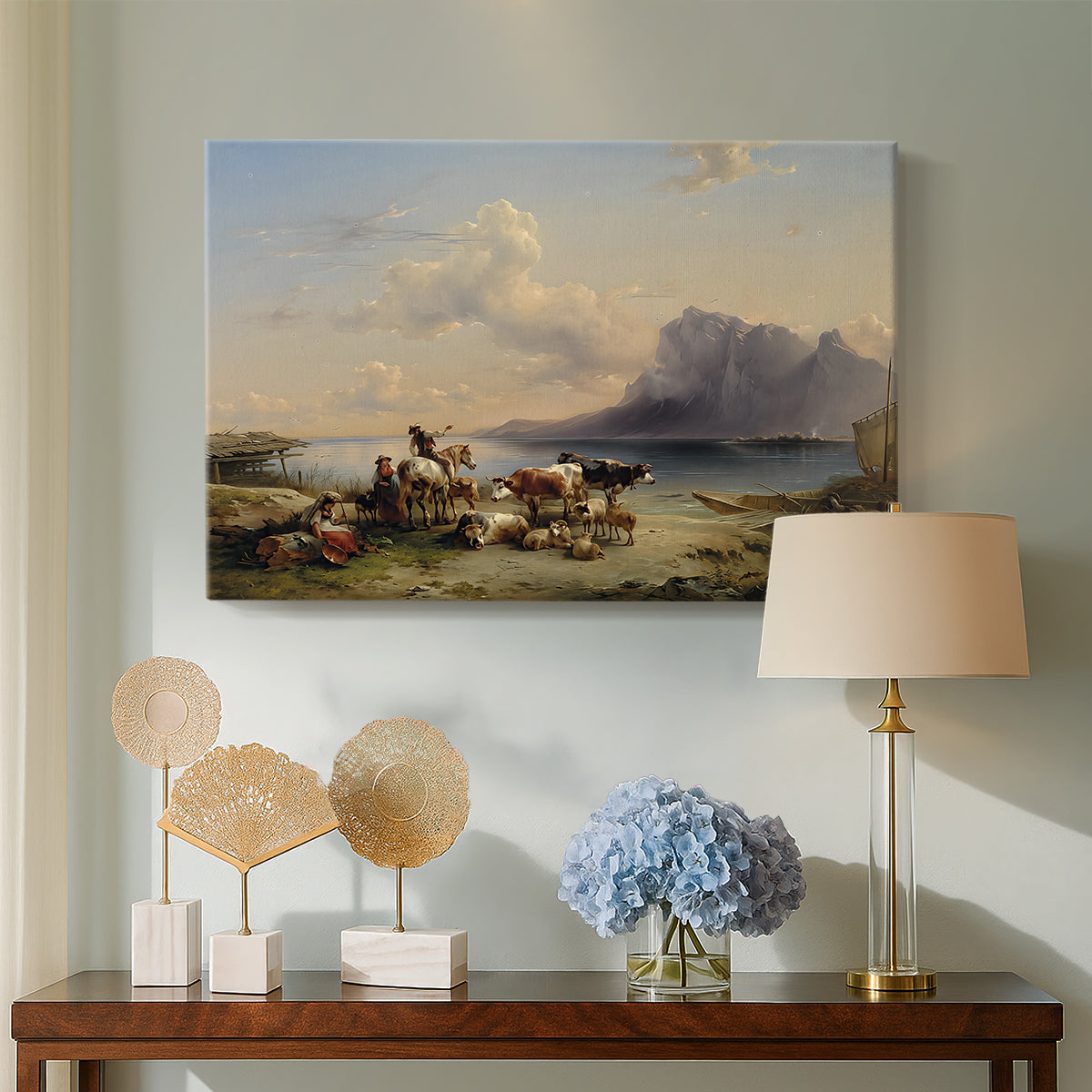 Canvas art print featuring an alpine landscape with figures and animals, displayed above a styled console table