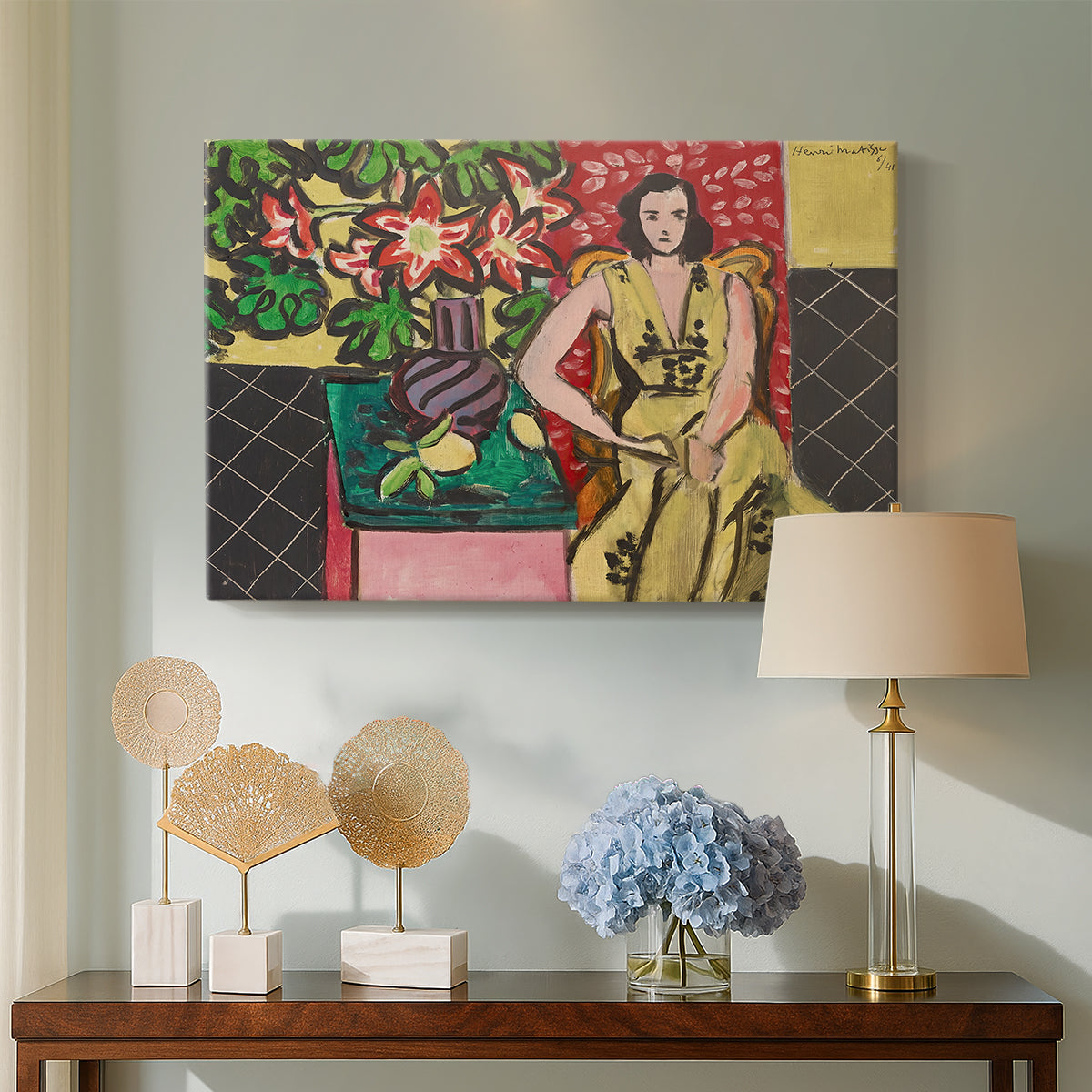 Canvas art print featuring a colorful interior with a seated woman and blooming flowers, displayed above a styled console table
