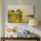 Canvas art print featuring an impressionist landscape with buildings along quiet canal, displayed above a styled console table