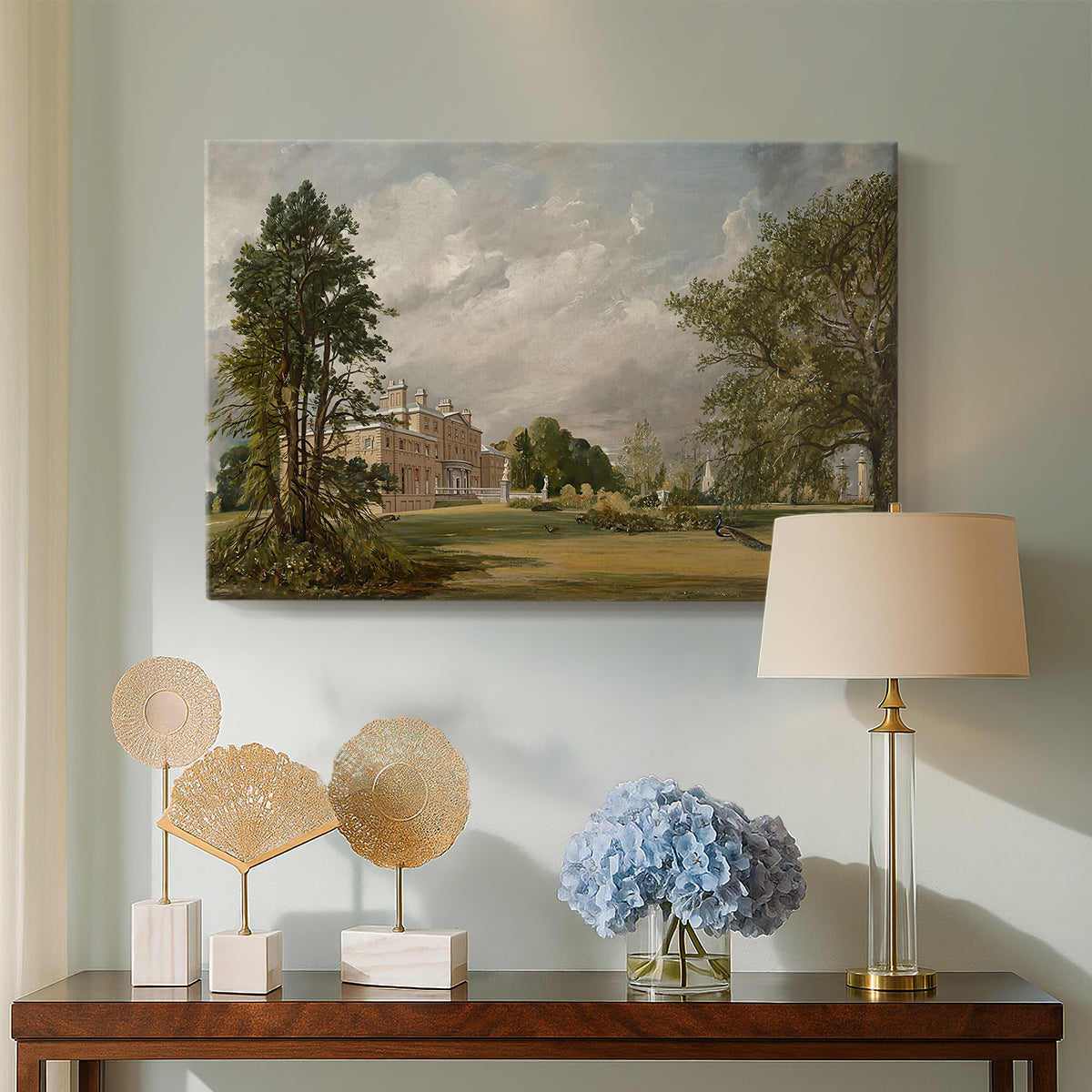 Canvas art print featuring a pastoral composition with building, displayed above a styled console table