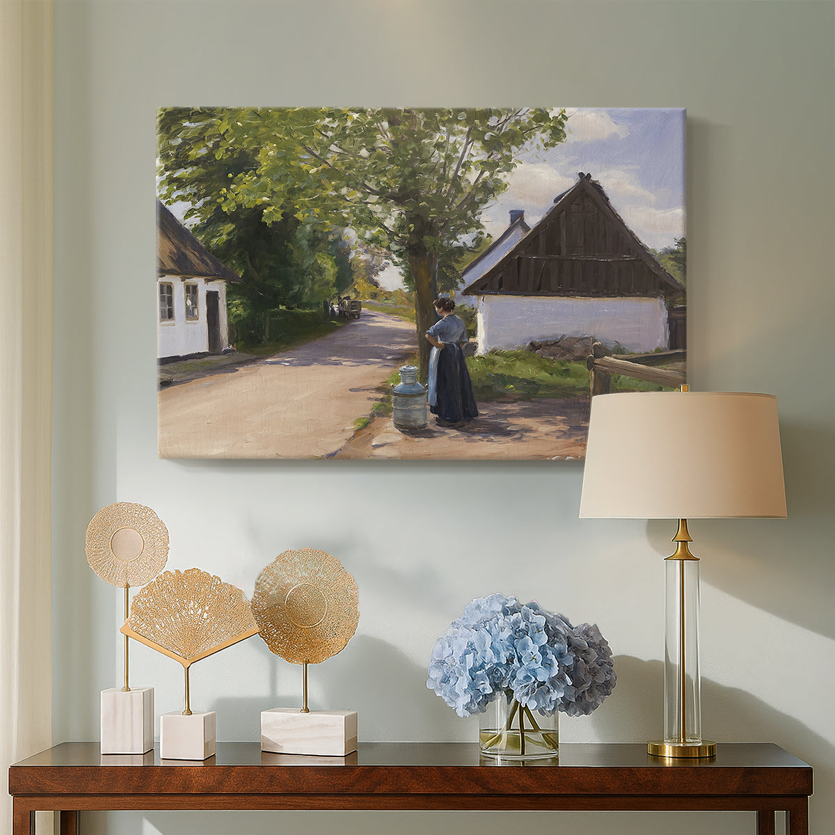 Canvas art print featuring a countryside scene with figures exchanging goods outdoors, displayed above a styled console table