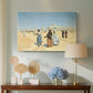 Canvas art print featuring a scene of figures crossing sandy terrain with distant skyline, displayed above a styled console table
