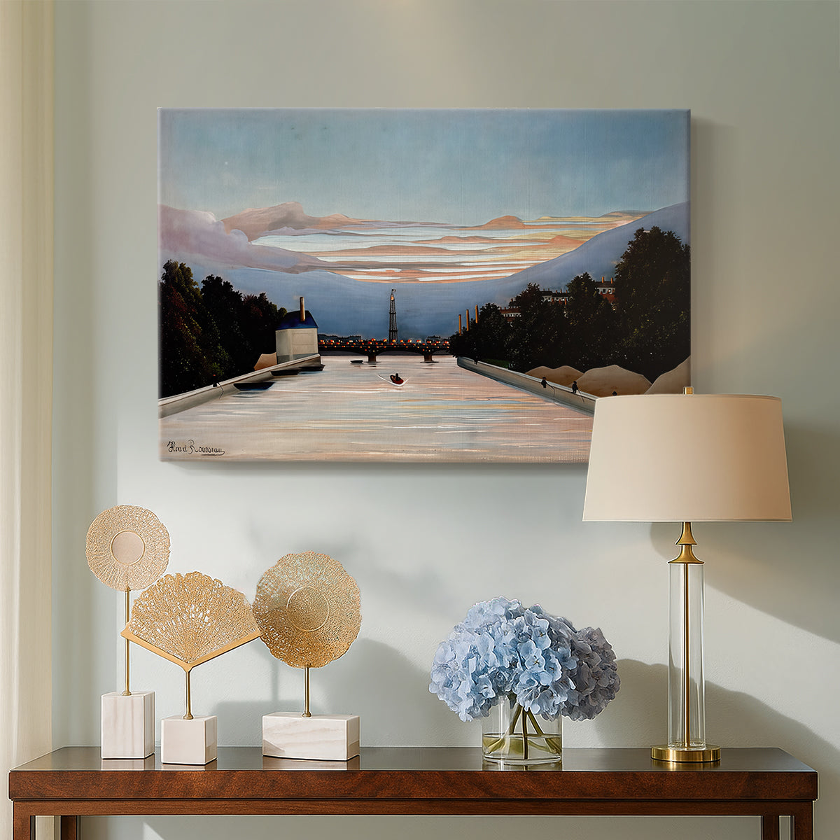 Canvas art print featuring a naïve cityscape with tower and surrounding greenery, displayed above a styled console table