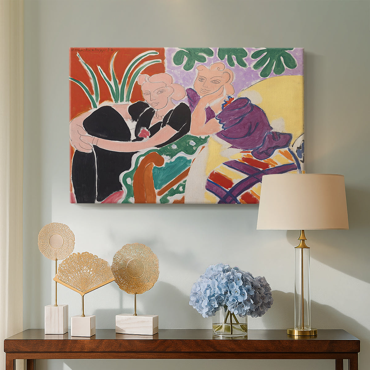 Canvas art print featuring an expressive interior composition centered on two figures, displayed above a styled console table