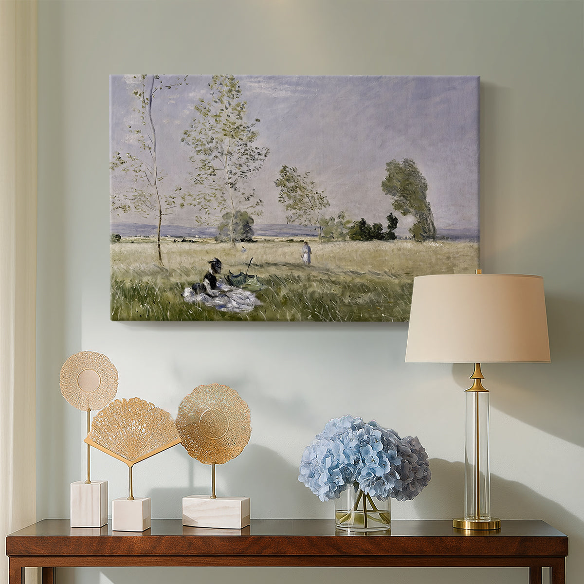 Canvas art print featuring a sunlit meadow with woman surrounded by greenery, displayed above a styled console table