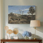 Canvas art print featuring a pastoral landscape with trees and rolling terrain, displayed above a styled console table