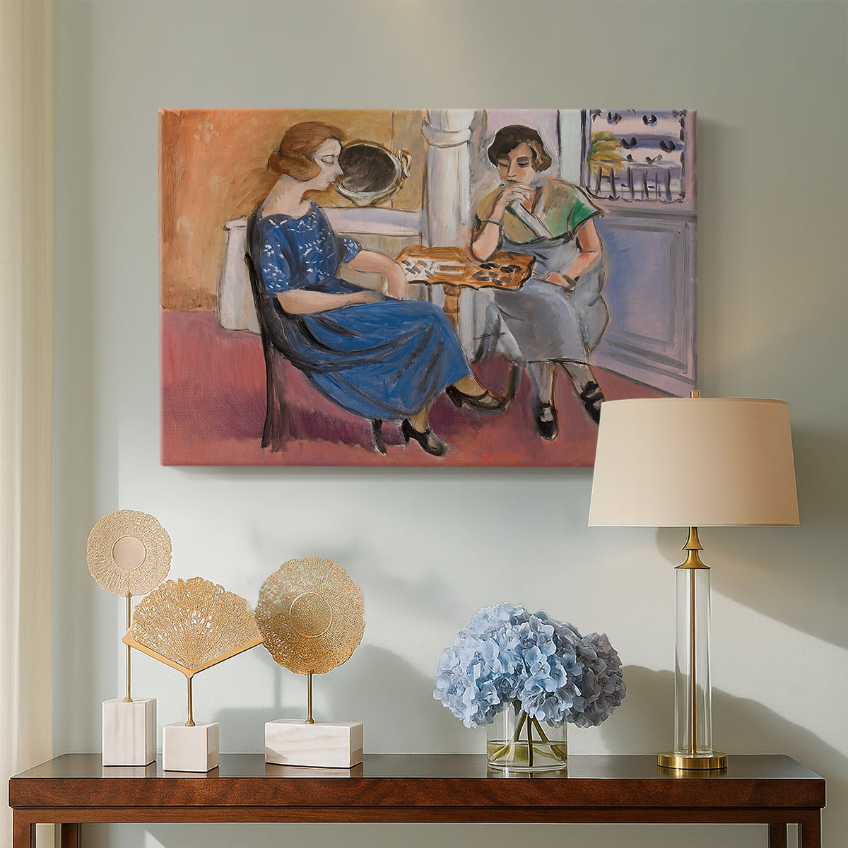 Canvas art print featuring a stylized interior with seated figures playing at a table, displayed above a styled console table