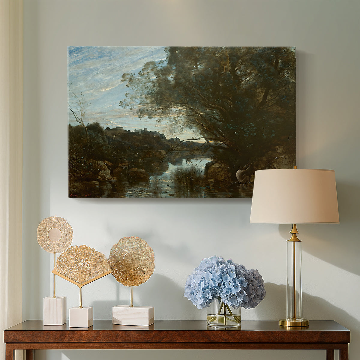 Canvas art print featuring an atmospheric landscape with lake and layered terrain, displayed above a styled console table
