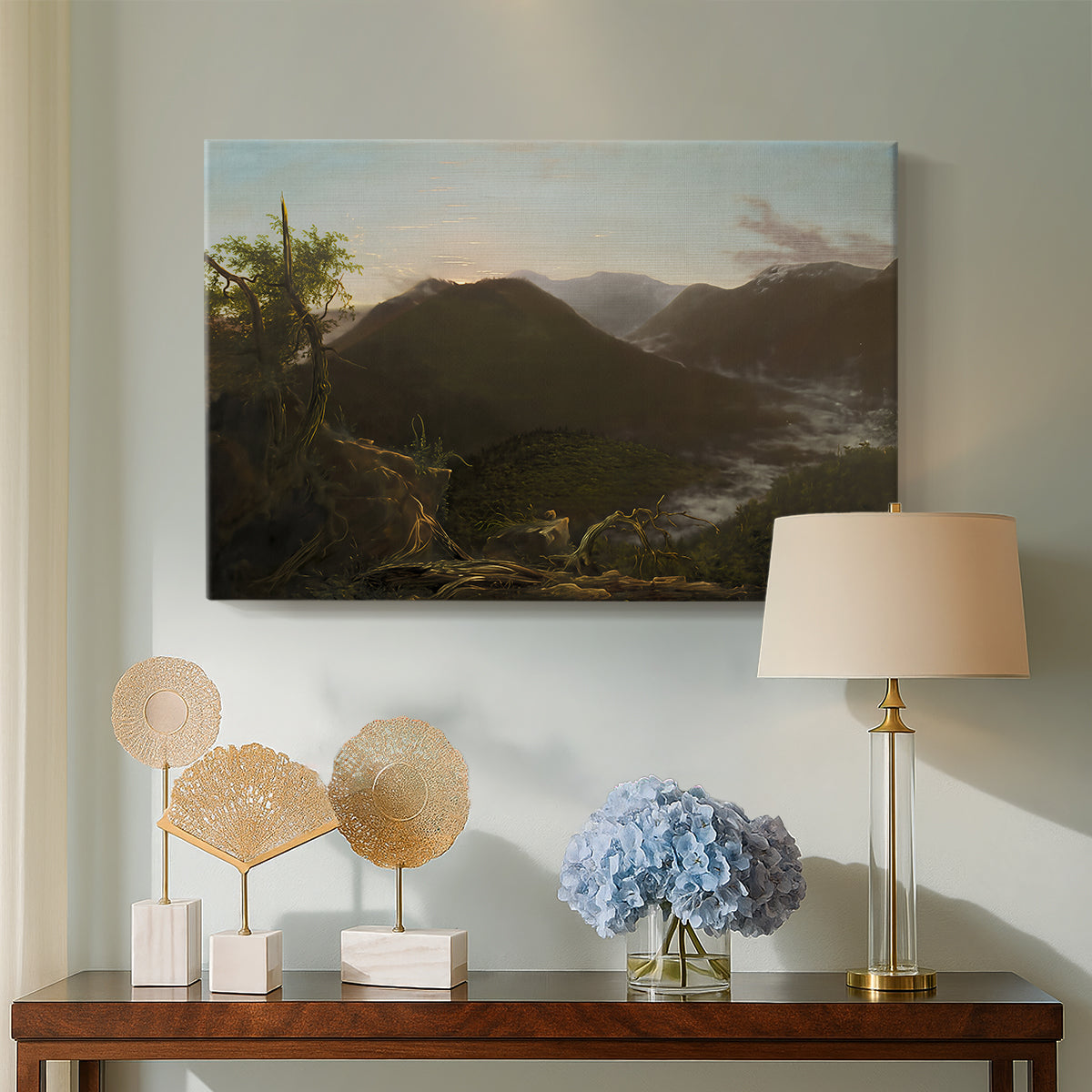 Canvas art print featuring a scenic sunrise view with deep valley and layered peaks, displayed above a styled console table