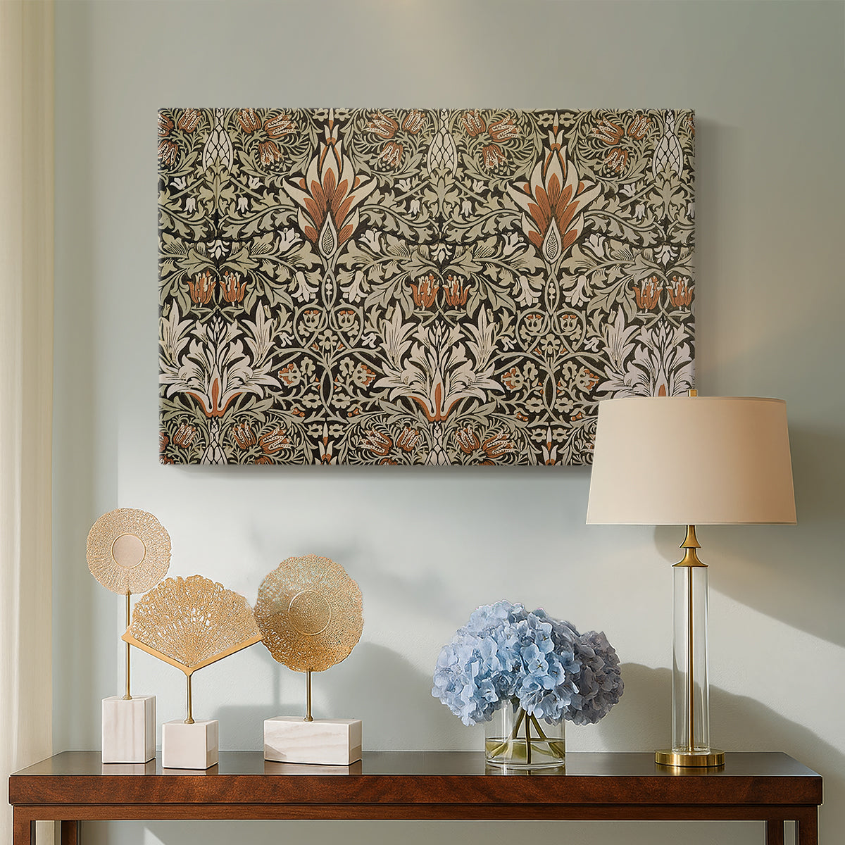 Canvas art print featuring a patterned design with alternating leaves and blossoms in muted tones, displayed above a styled console table