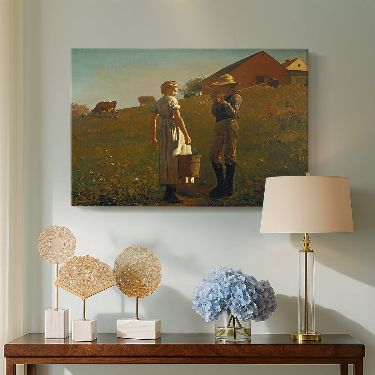 Canvas art print featuring a countryside composition with figures positioned near simple structure, displayed above a styled console table