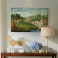 Canvas art print featuring a pastoral setting with water, figures, and greenery, displayed above a styled console table