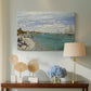 Canvas art print featuring an impressionist coastal view with colorful sails and shoreline activity, displayed above a styled console table