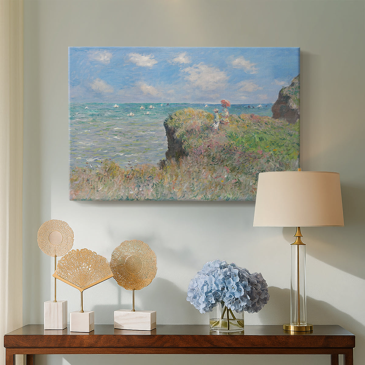 Canvas art print featuring a coastal cliff scene with grass, wind, and expansive sea view, displayed above a styled console table