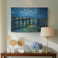 Canvas art print featuring a post-impressionist scene emphasizing reflections and deep blue sky, displayed above a styled console table