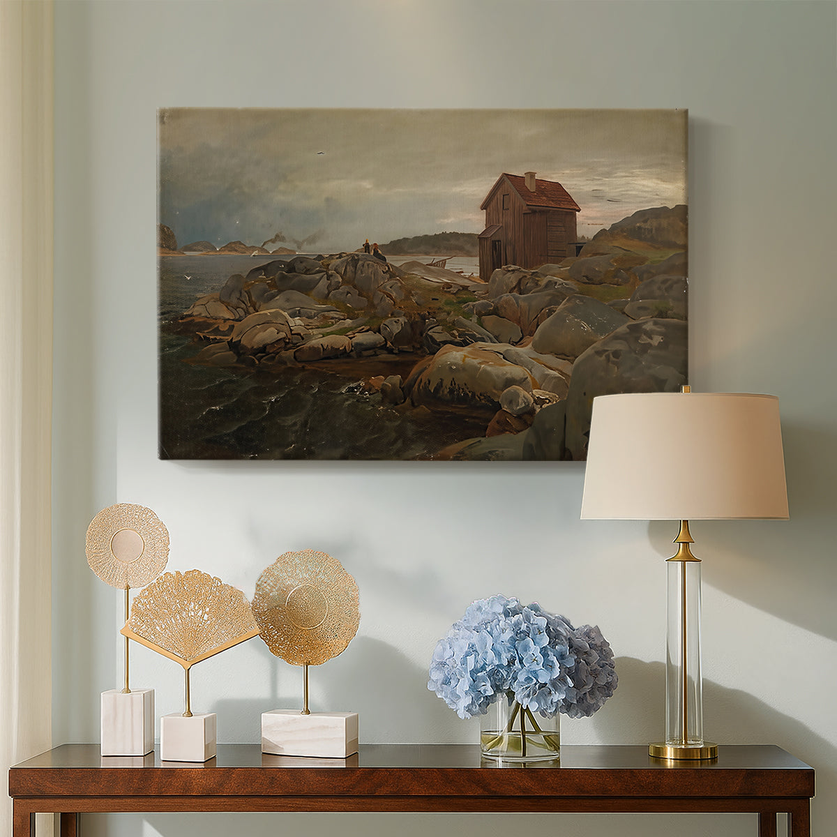 Canvas art print featuring a rustic coastal scene with house and maritime elements, displayed above a styled console table