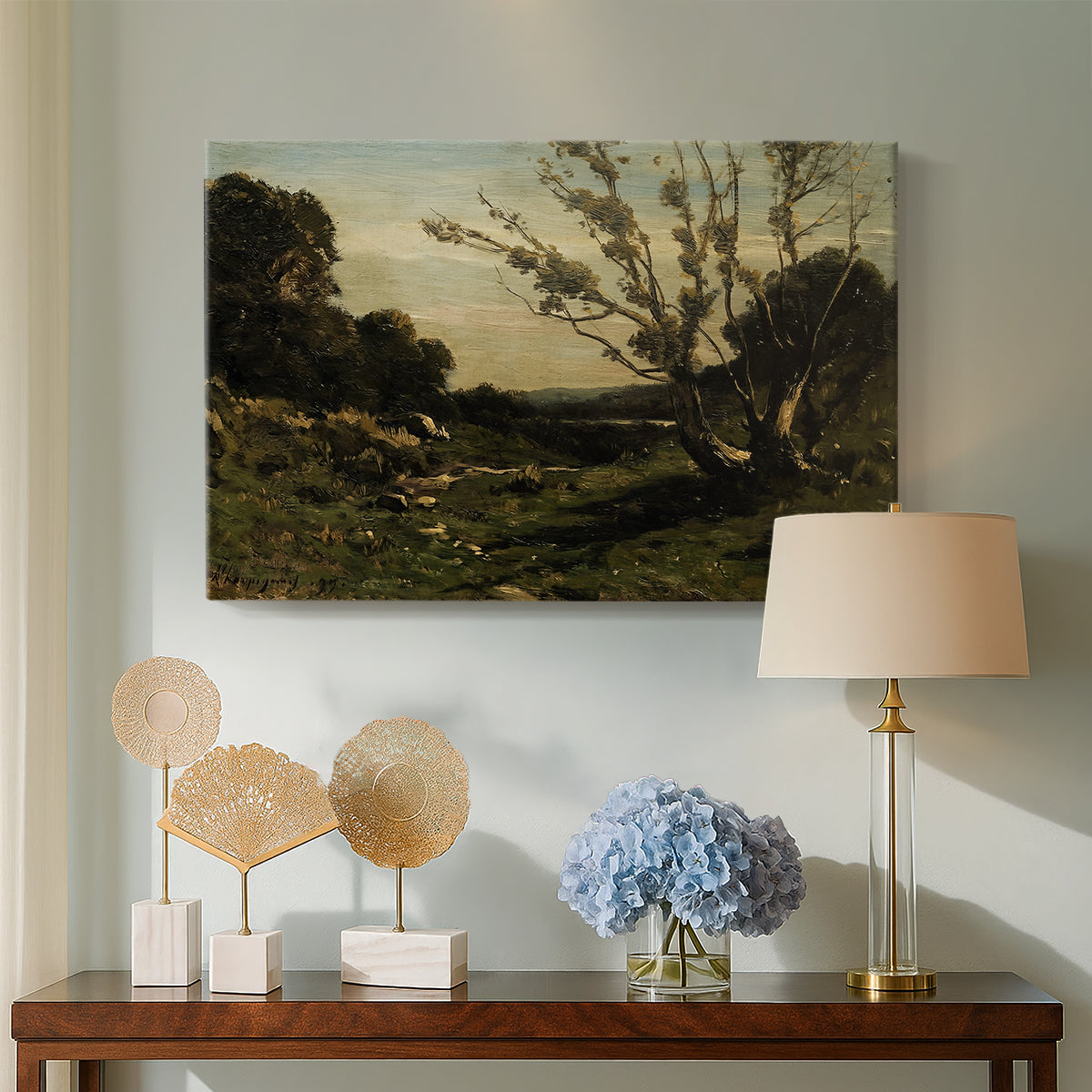 Canvas art print featuring a French countryside at dawn with trees and open terrain, displayed above a styled console table