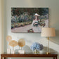 Canvas art print featuring a figure resting in colorful garden under soft light, displayed above a styled console table