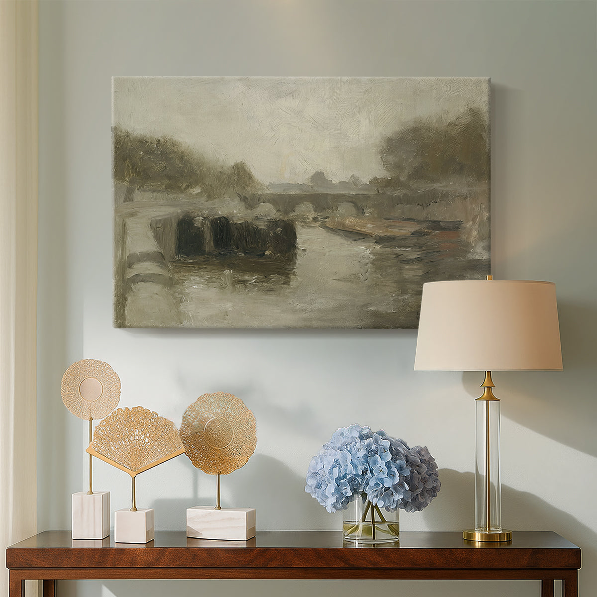 Canvas art print featuring a quiet riverside view with a bridge and subdued tones, displayed above a styled console table
