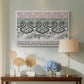 Canvas art print featuring a patterned composition featuring symmetrical abstract elements, displayed above a styled console table
