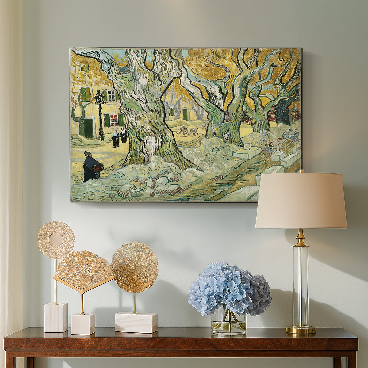 Canvas art print featuring a tree-lined path composition with activity along roadside, displayed above a styled console table