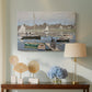 Canvas art print featuring a harbor basin filled with boats under soft sky, displayed above a styled console table
