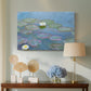 Canvas art print featuring a tranquil water surface covered with blooming lilies, displayed above a styled console table