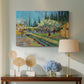 Canvas art print featuring an agricultural scene with orchard framed by vertical trees, displayed above a styled console table
