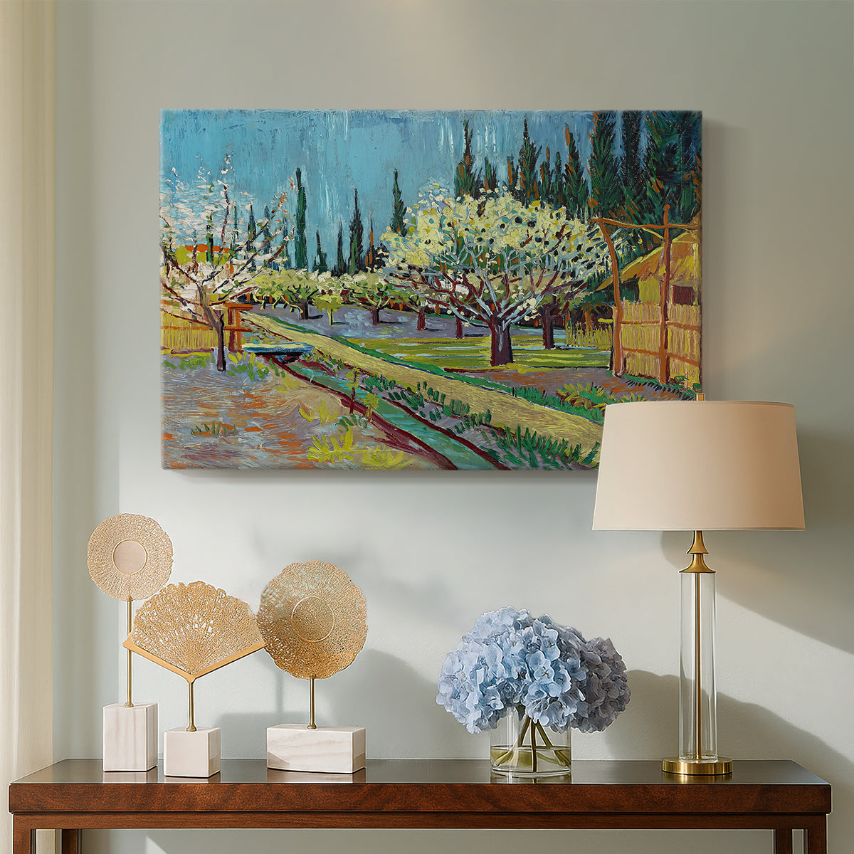 Canvas art print featuring an agricultural scene with orchard framed by vertical trees, displayed above a styled console table