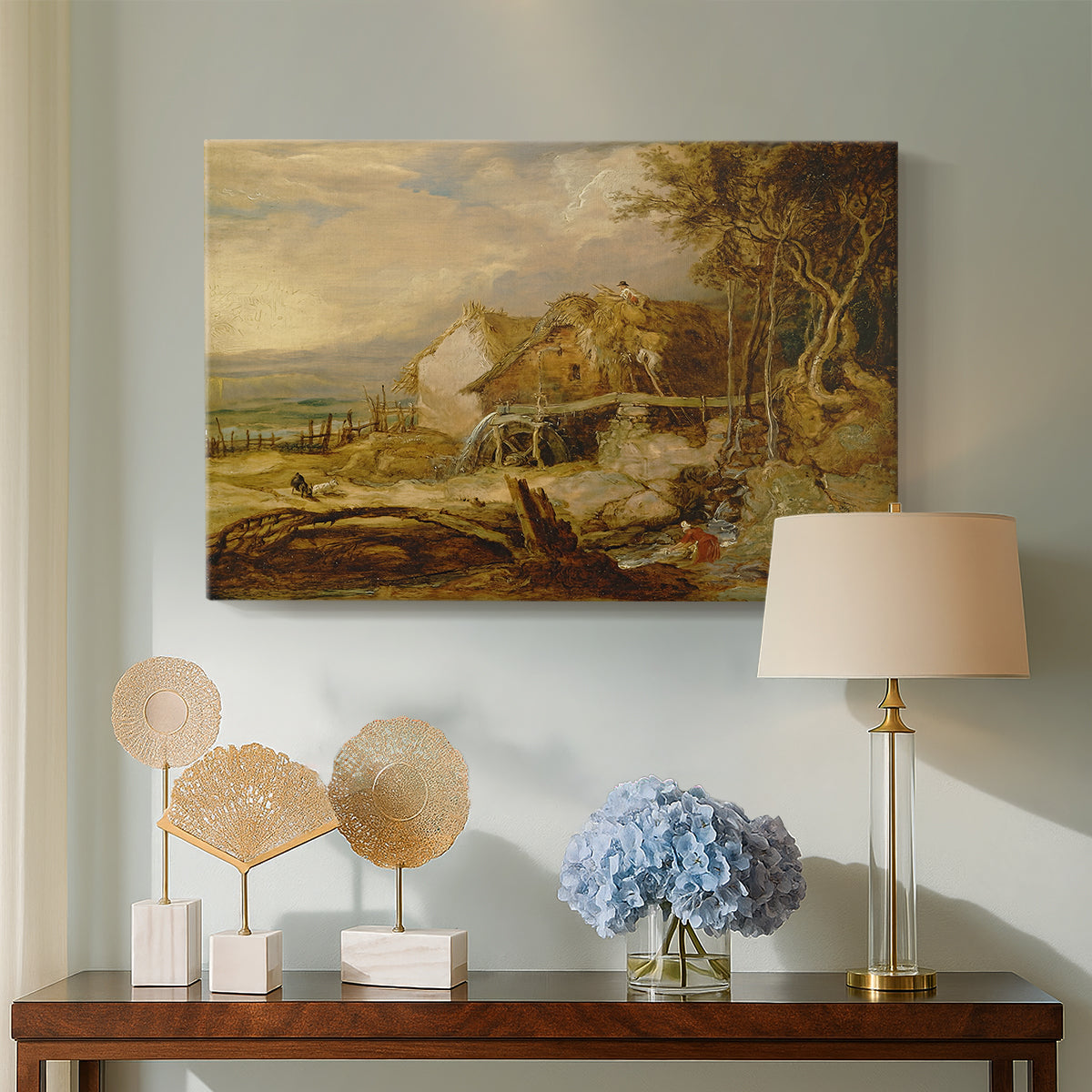 Canvas art print featuring a countryside scene with architecture and moving water, displayed above a styled console table