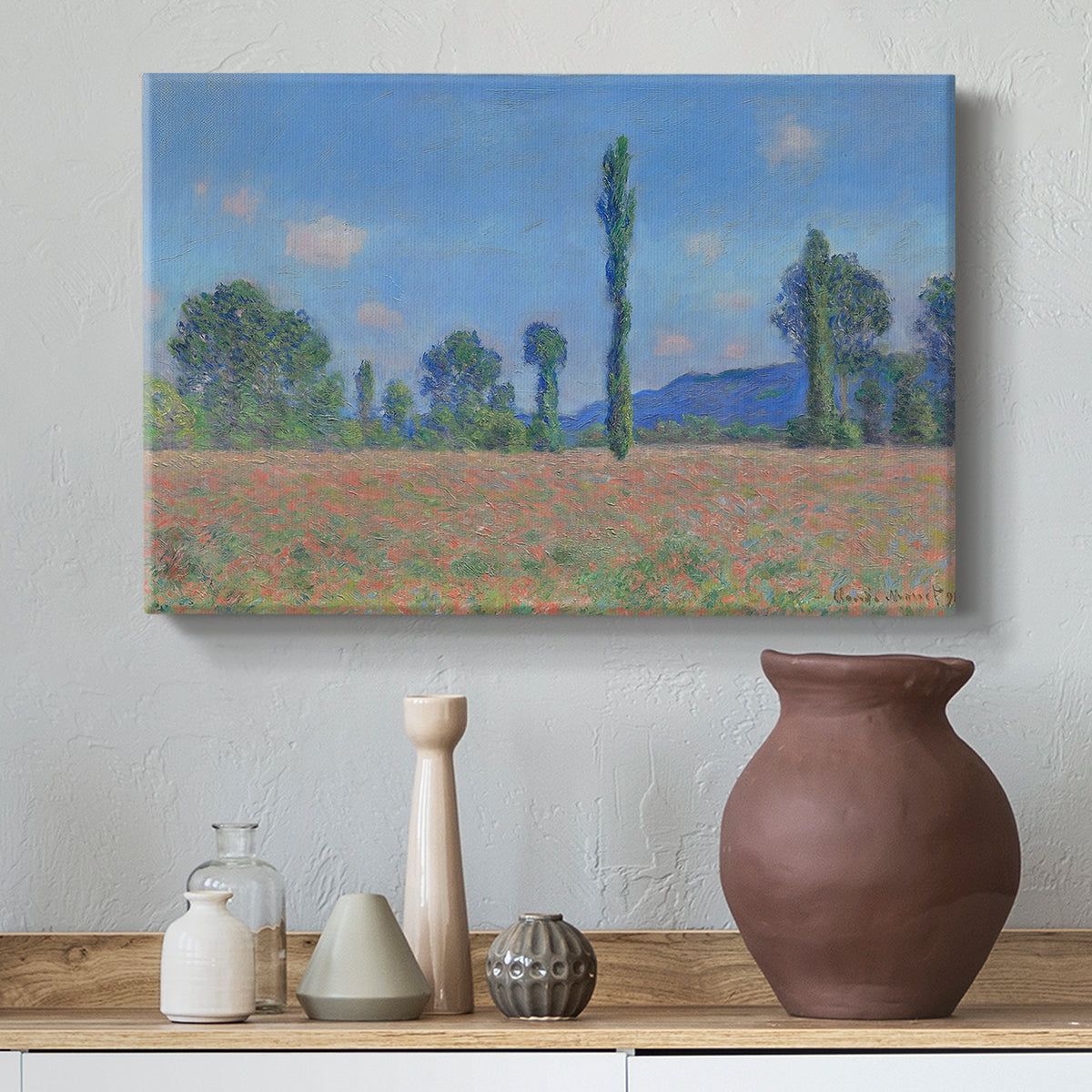 Canvas art print featuring a vibrant meadow scene with flowers and vertical tree forms, styled above a decorative console