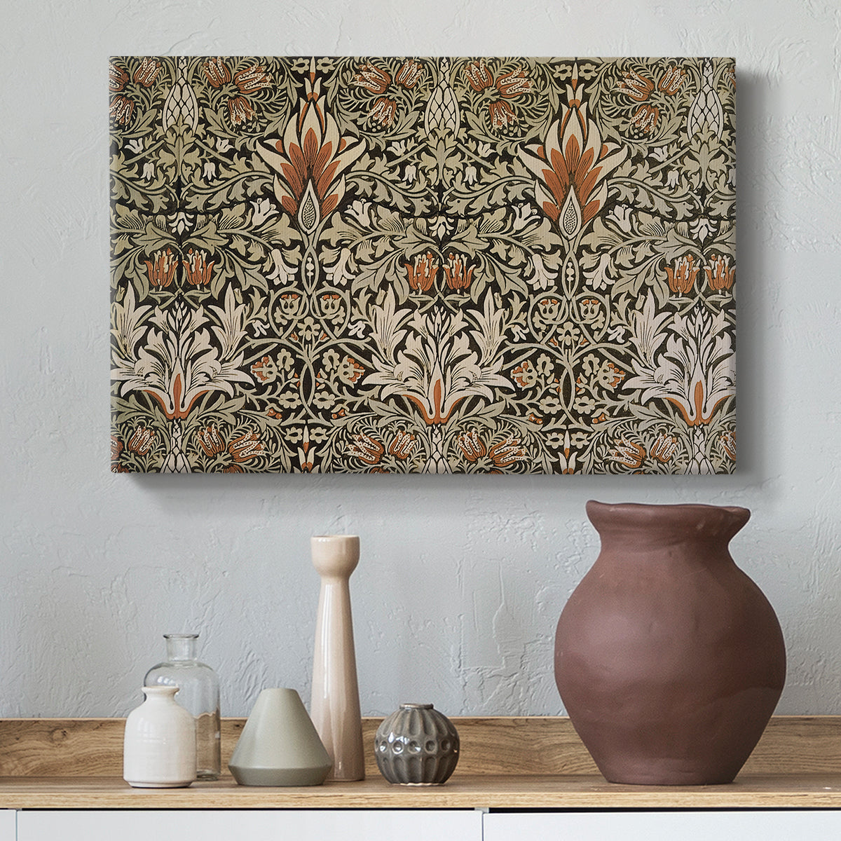 Canvas art print featuring a patterned design with alternating leaves and blossoms in muted tones, styled above a decorative console