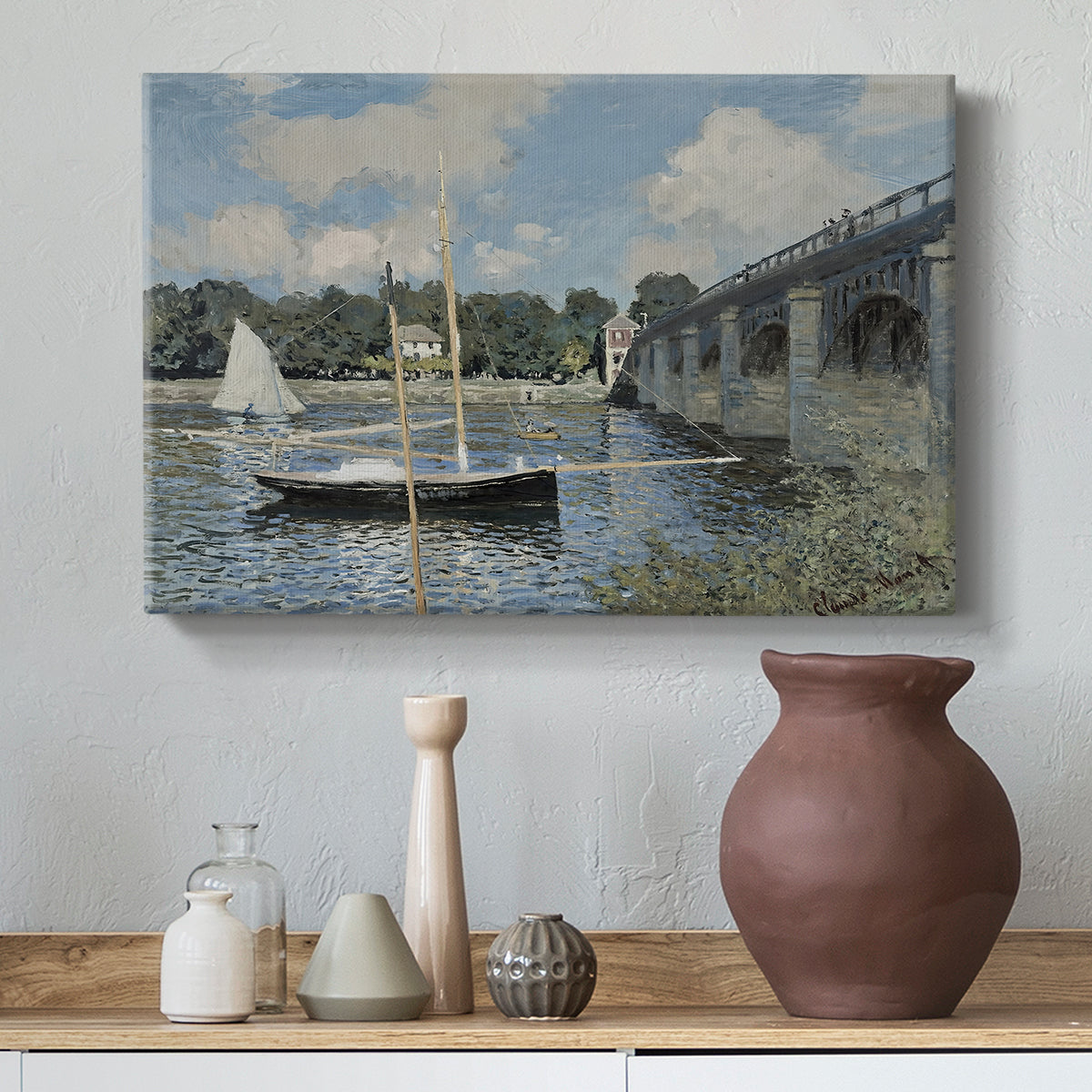 Canvas art print featuring a calm waterway with bridge structure and leisure boats, styled above a decorative console
