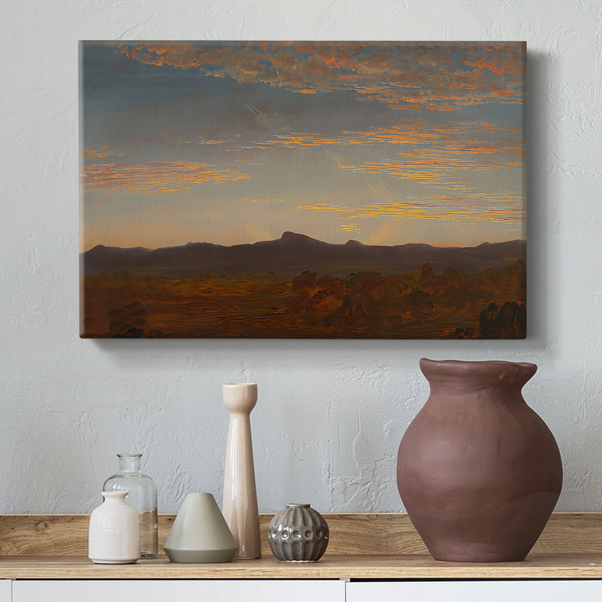 Canvas art print featuring a romantic landscape with layered terrain and soft evening light, styled above a decorative console