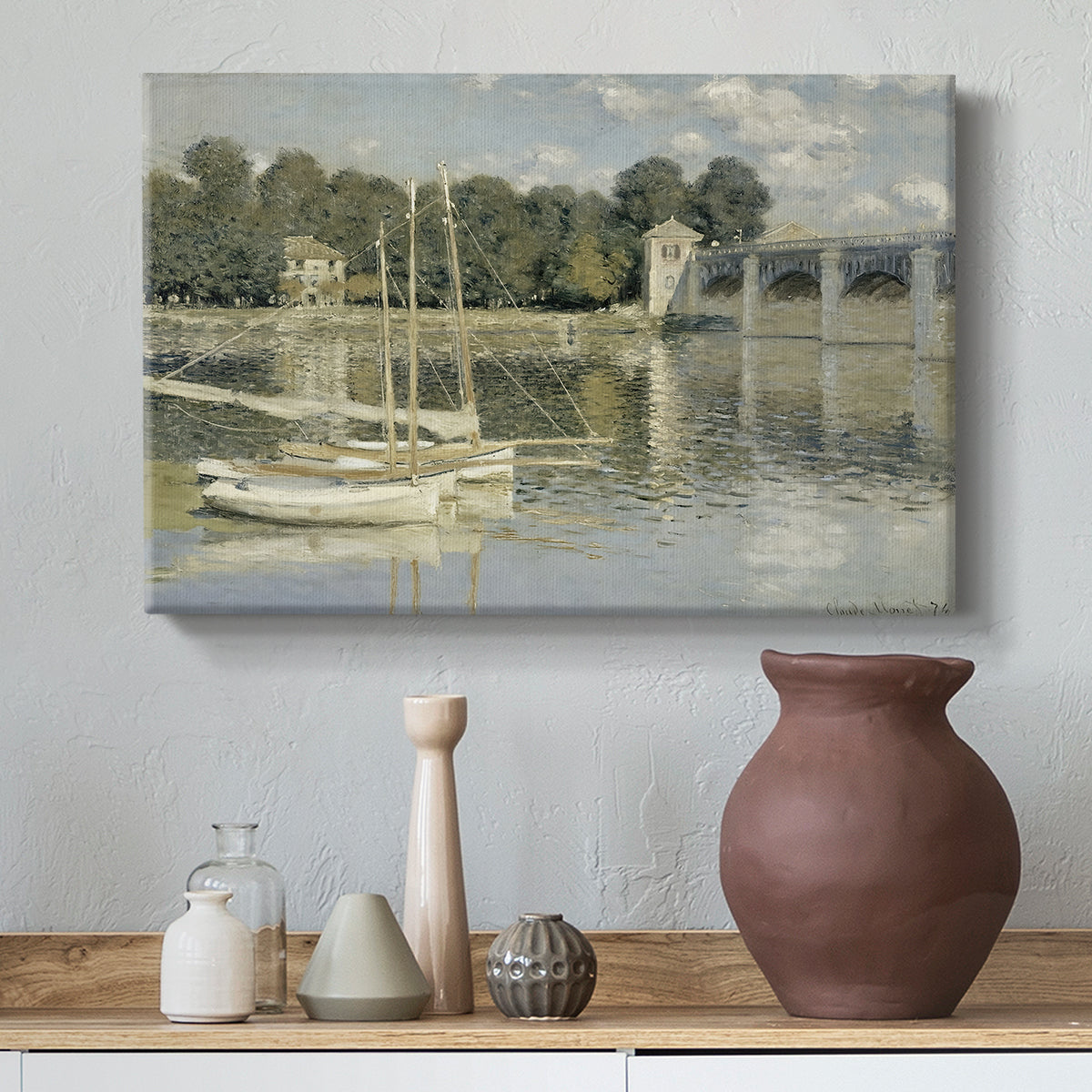 Canvas art print featuring a bright landscape featuring bridge and sailboats on calm water, styled above a decorative console