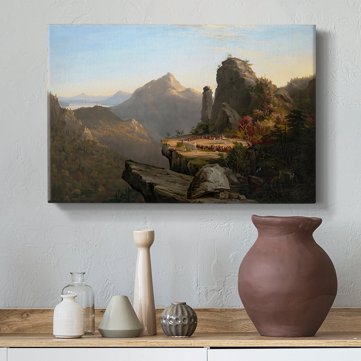 Canvas art print featuring an expansive landscape featuring cliffs, water, and distant mountains, styled above a decorative console