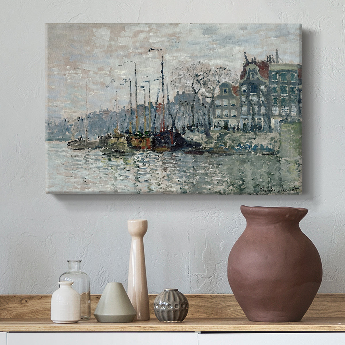 Canvas art print featuring an urban waterway with docked boats and European buildings, styled above a decorative console