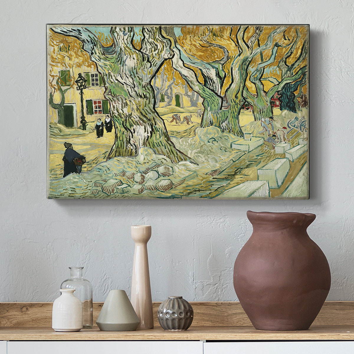 Canvas art print featuring a tree-lined path composition with activity along roadside, styled above a decorative console