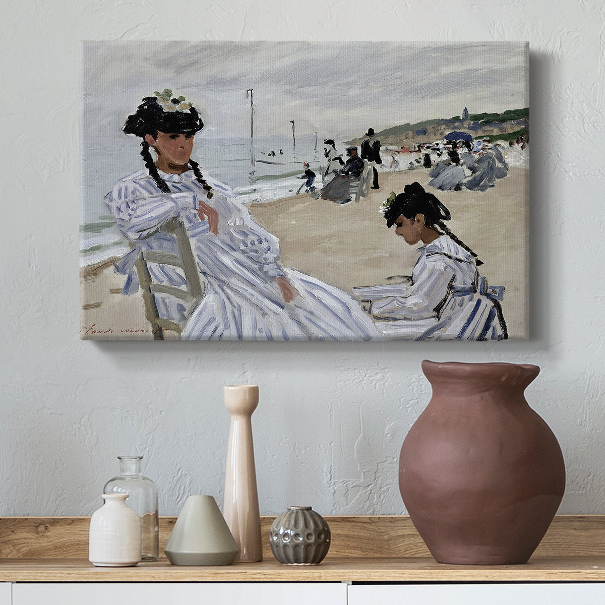 Canvas art print featuring a beach setting with people relaxing under umbrellas, styled above a decorative console