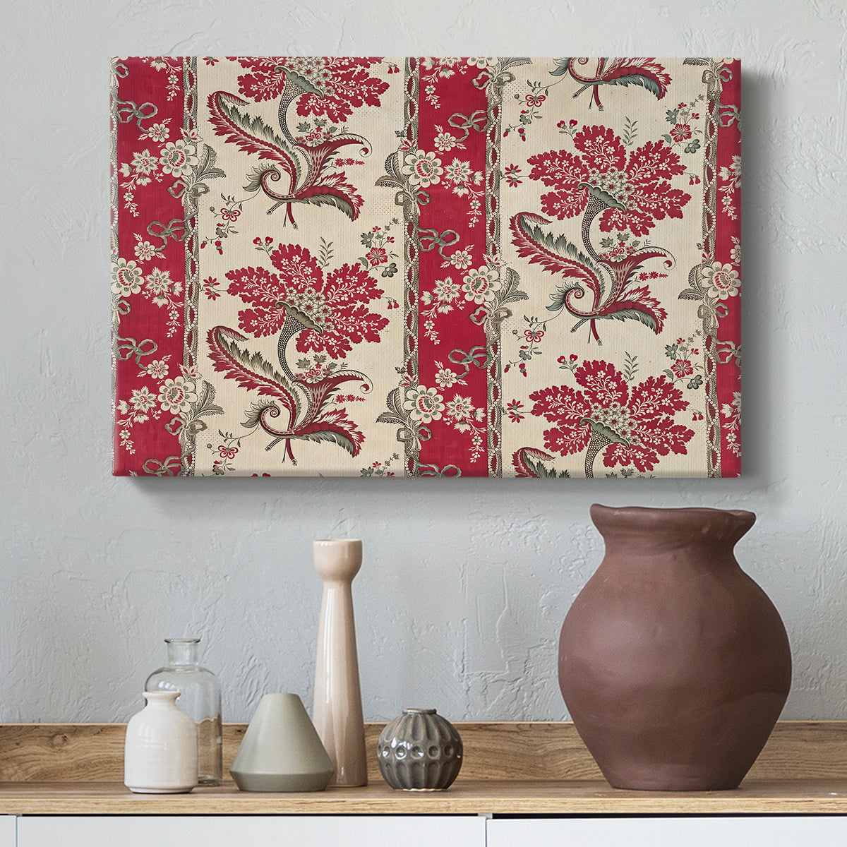 Canvas art print featuring a decorative composition featuring repeated botanical groupings, styled above a decorative console