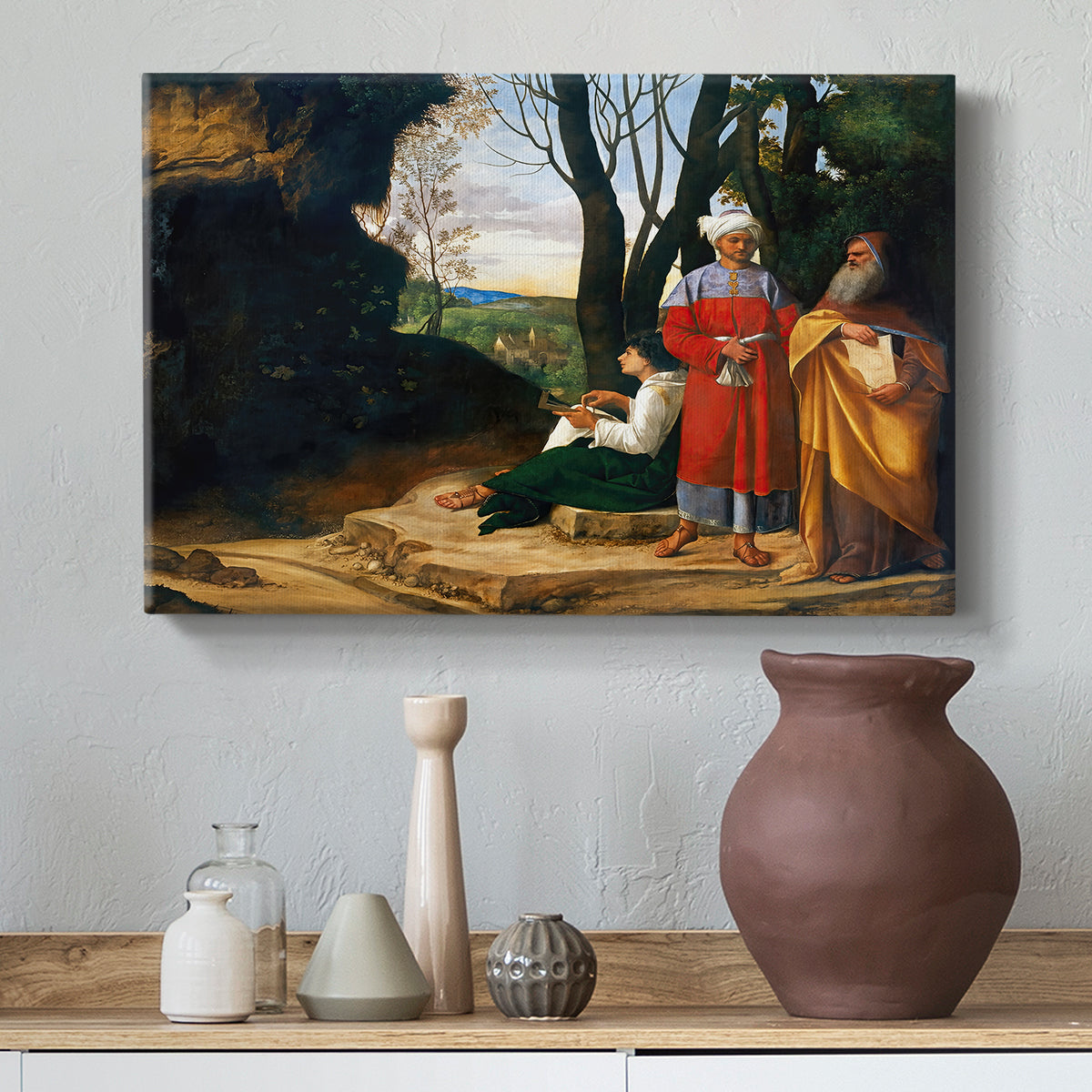 Canvas art print featuring a group of men posed near rocky terrain with distant landscape, styled above a decorative console