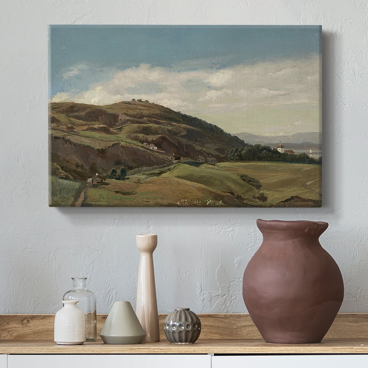 Canvas art print featuring a scenic landscape of Ekeberg hills with Oslo church and expansive sky, styled above a decorative console