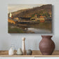 Canvas art print featuring a waterfront setting with village structures and reflections, styled above a decorative console