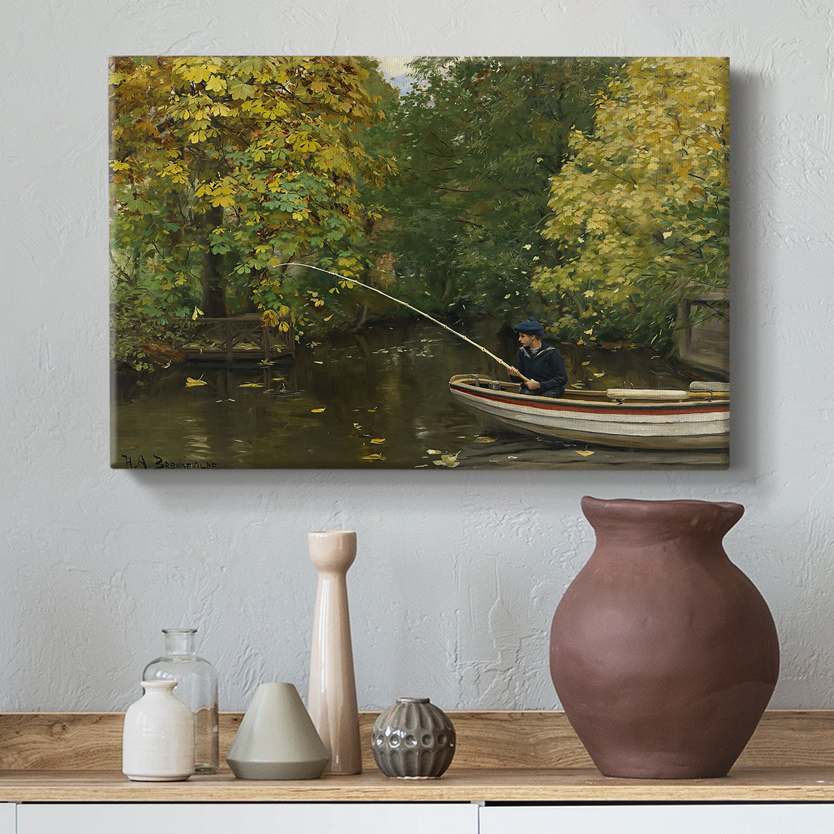 Canvas art print featuring a rural landscape with boy focused on fishing activity, styled above a decorative console