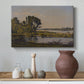 Canvas art print featuring a tranquil natural setting with river and distant horizon, styled above a decorative console