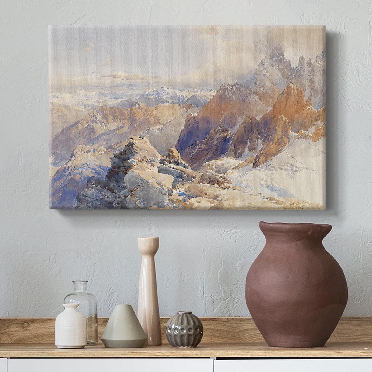 Canvas art print featuring a panoramic alpine view with snow and rocky cliffs, styled above a decorative console