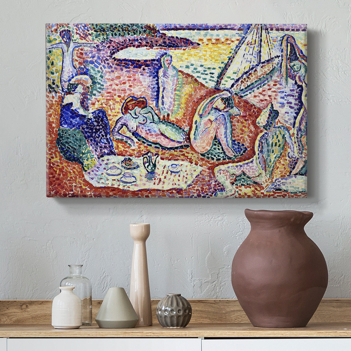 Canvas art print featuring an expressive composition of people resting near the sea, styled above a decorative console