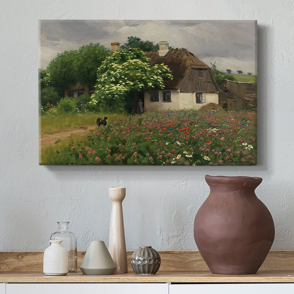 Canvas art print featuring a pastoral scene with house and colorful flowers in field, styled above a decorative console