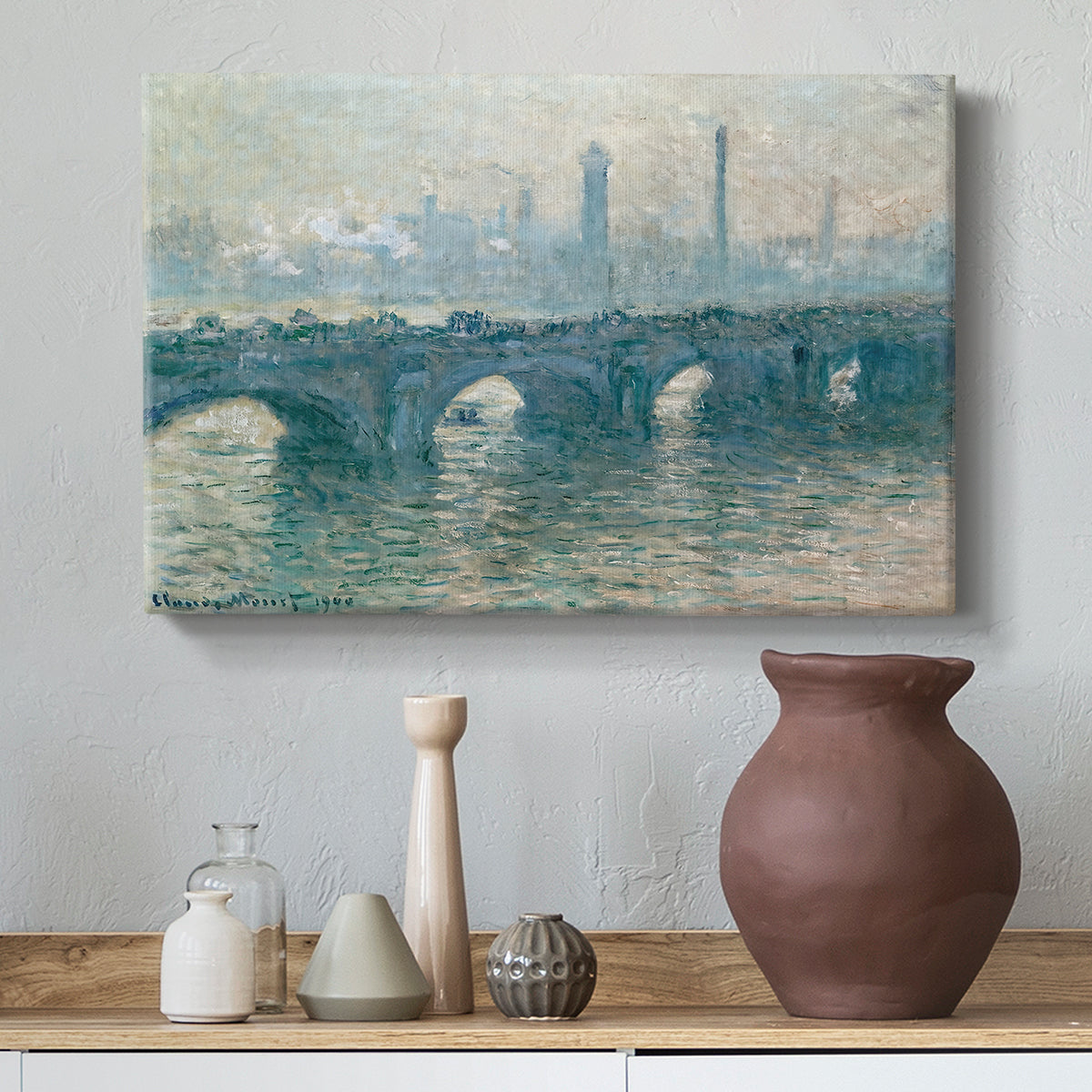 Canvas art print featuring a soft-toned river scene with bridge and muted skyline, styled above a decorative console