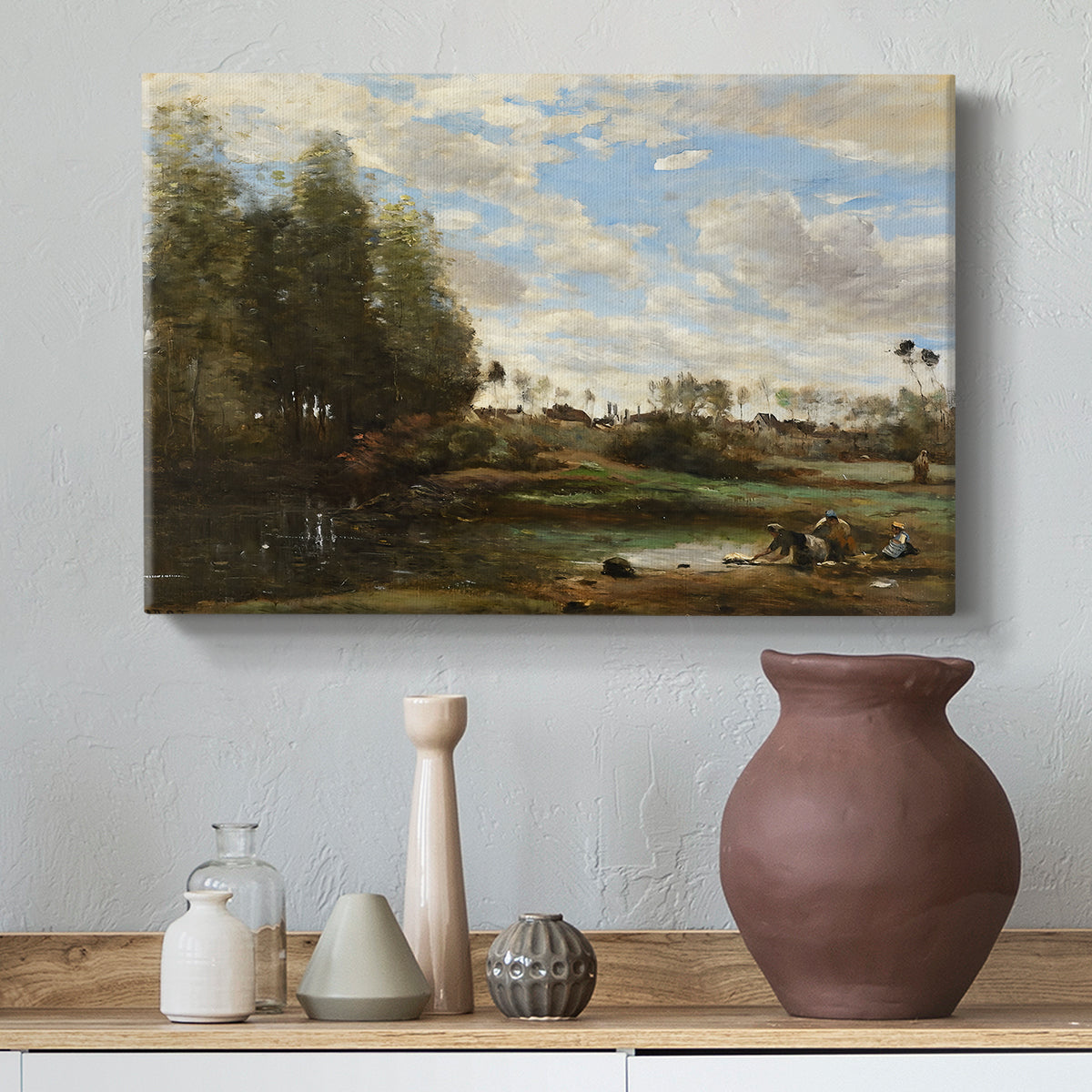Canvas art print featuring a soft landscape with figures and foliage near shoreline, styled above a decorative console